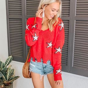 Red distressed sweater with white stars